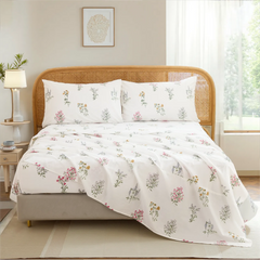 Full view of cotton wildflower floral sheet set on bed with rustic rattan headboard