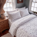country breeze ditsy floral duvet cover set ivory blue rose wood nightstand bedroom overview