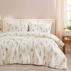  A bed with a cream-colored comforter and pillowcases featuring a delicate, small floral pattern in a cozy room.