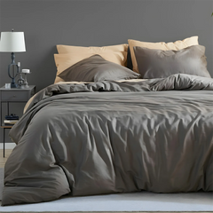 Close-up of dark gray duvet showing five pillow layers arrangement
