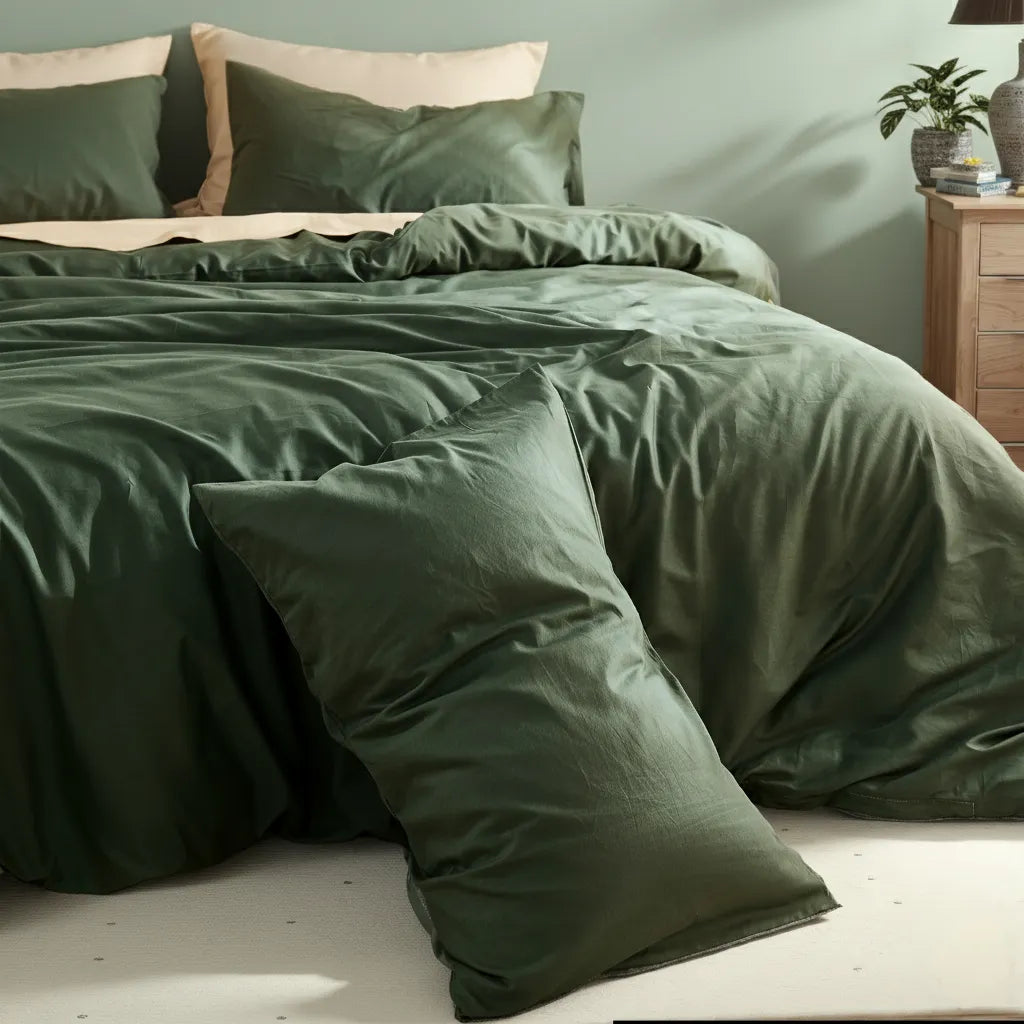 Close-up detail of dark green duvet fabric drape and folds, with upright display showing texture.