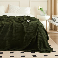 Dark Green Knitted Throw Blanket on Bed with Tassels and Natural Light