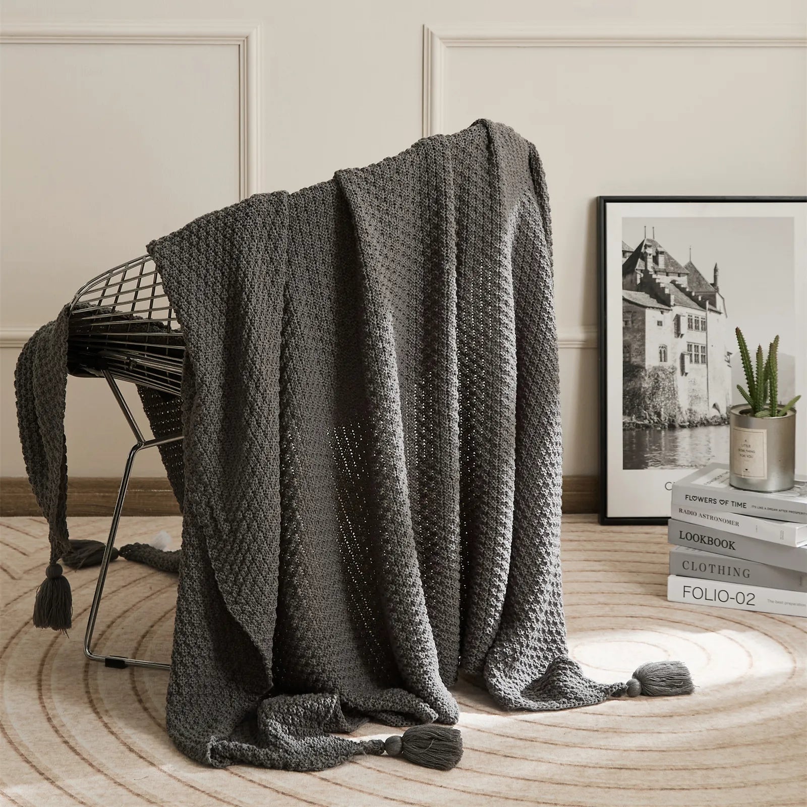 Dark Grey Knitted Throw Blanket on Metal Chair with Book Stack Decor
