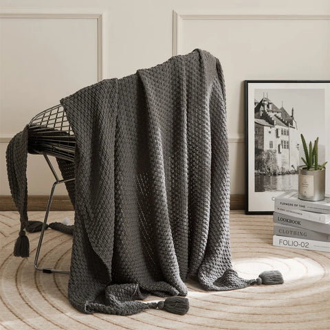 Dark Grey Knitted Throw Blanket on Metal Chair with Book Stack Decor