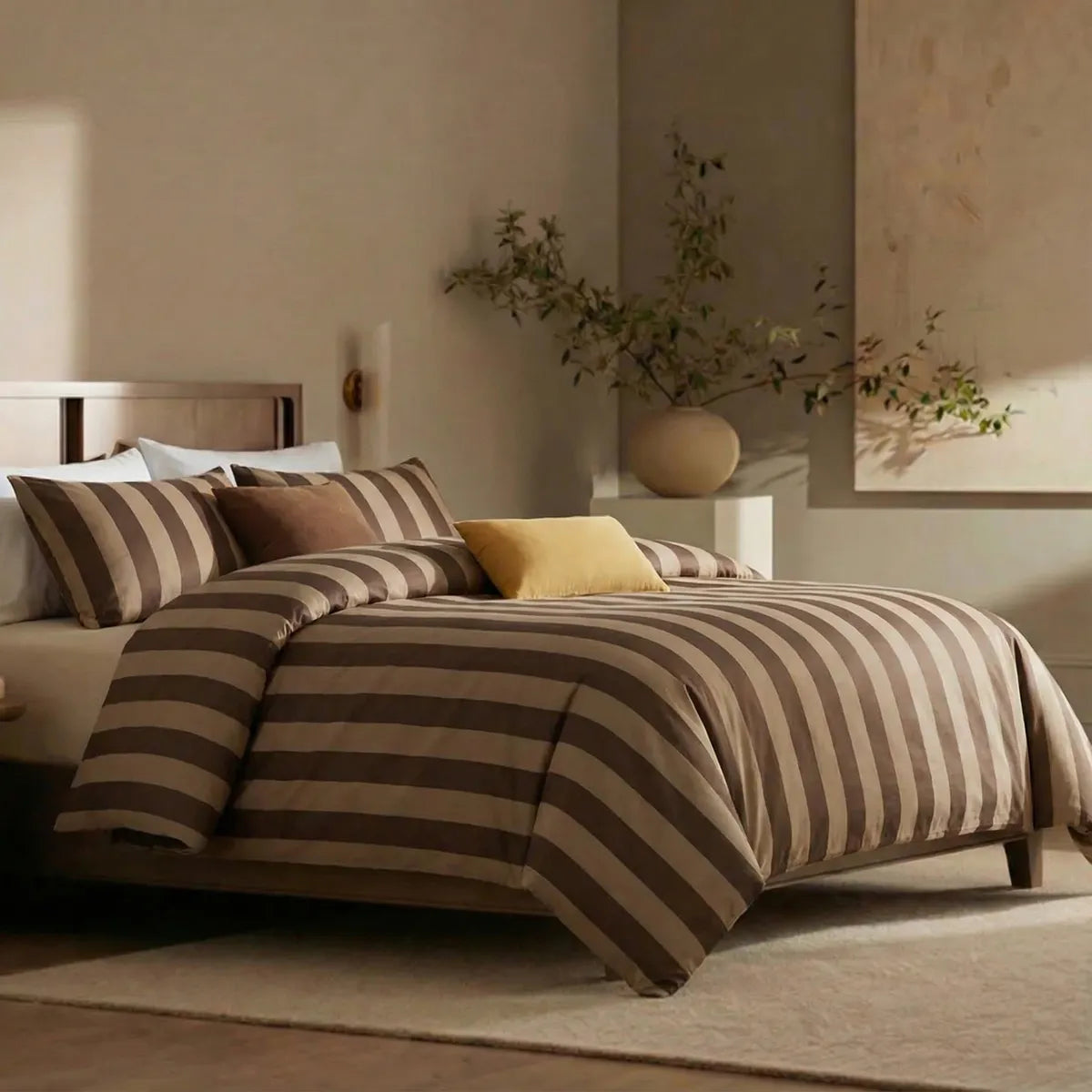 Angled shot of dark and light brown  striped duvet cover on bed