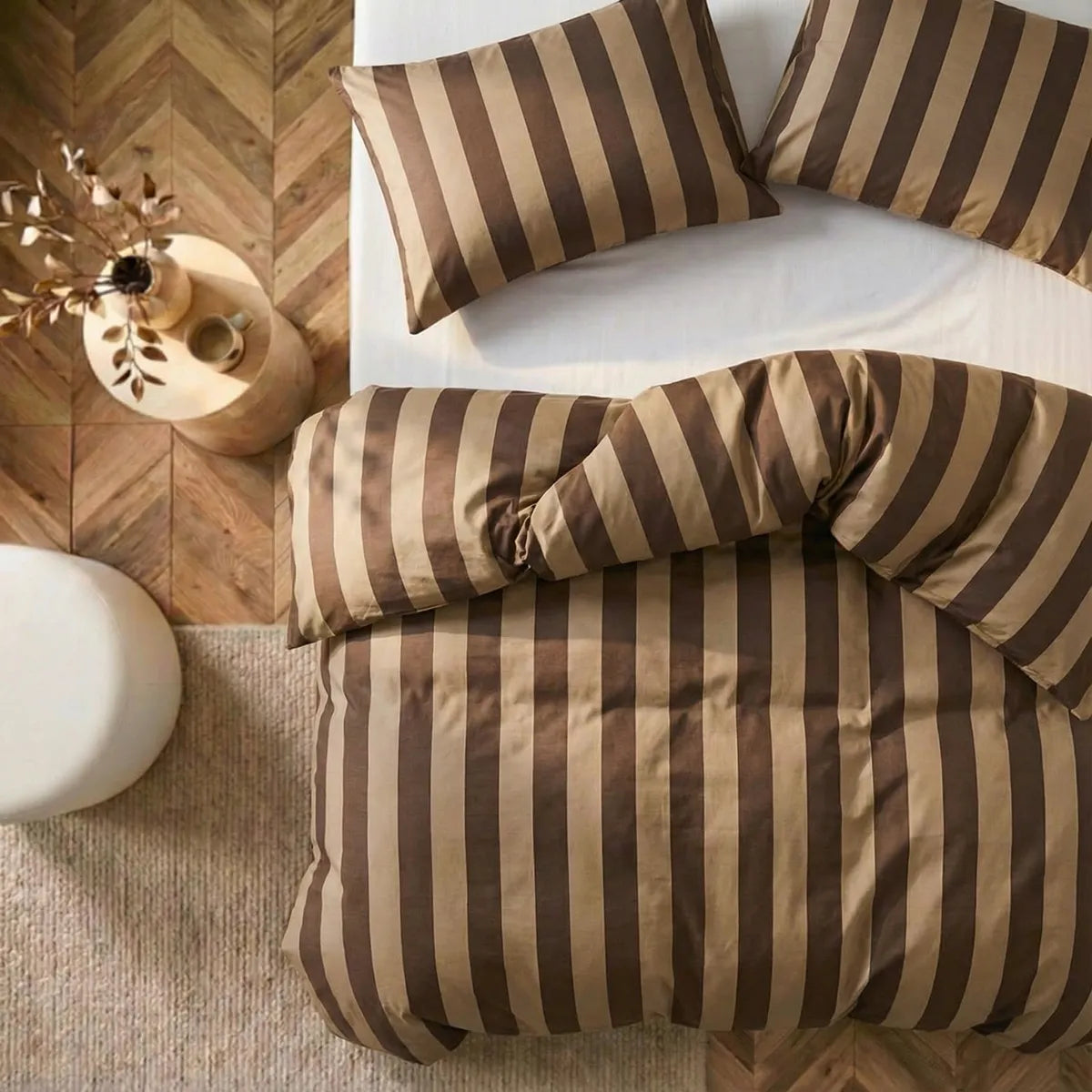 Overhead flat lay of dark and light brown striped duvet and cases