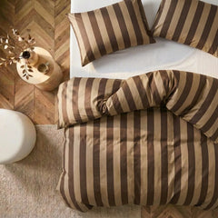 Overhead flat lay of dark and light brown striped duvet and cases