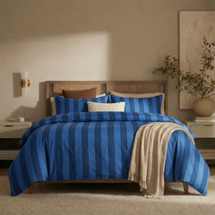 Full front view of dark blue and deep blue striped bedding set