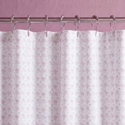 dreamy pastel shower curtain white metal rings mauve wall close up