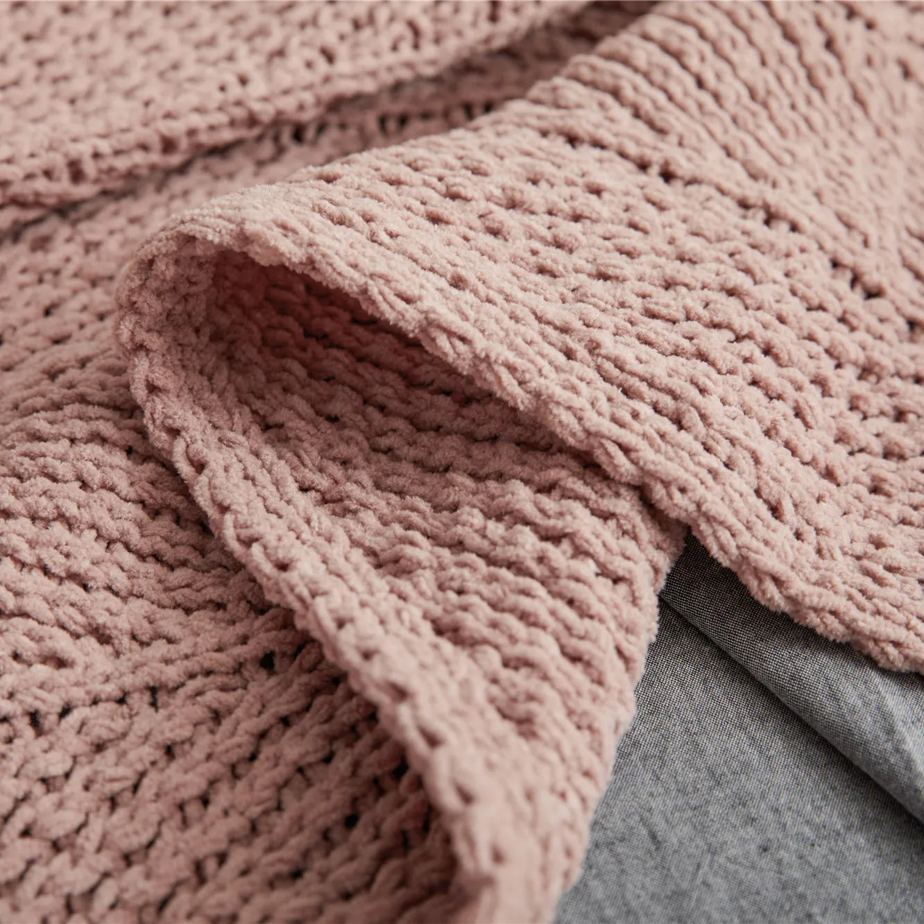 Close up of dusty pink chunky knit texture showing soft, detailed weave