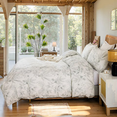 Side view of the elegant sketch floral duvet cover set on a bed.