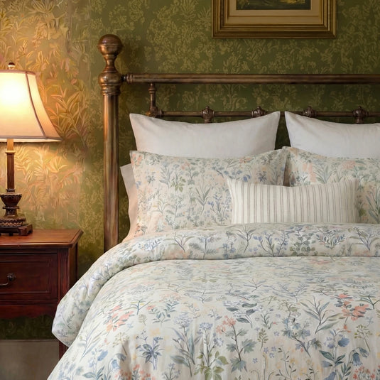heirloom wildflower symphony duvet cover set styled on victorian brass bed with green floral wallpaper