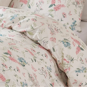 side view of white cotton quilt cover with fine botanical sprigs in a modern farmhouse interior