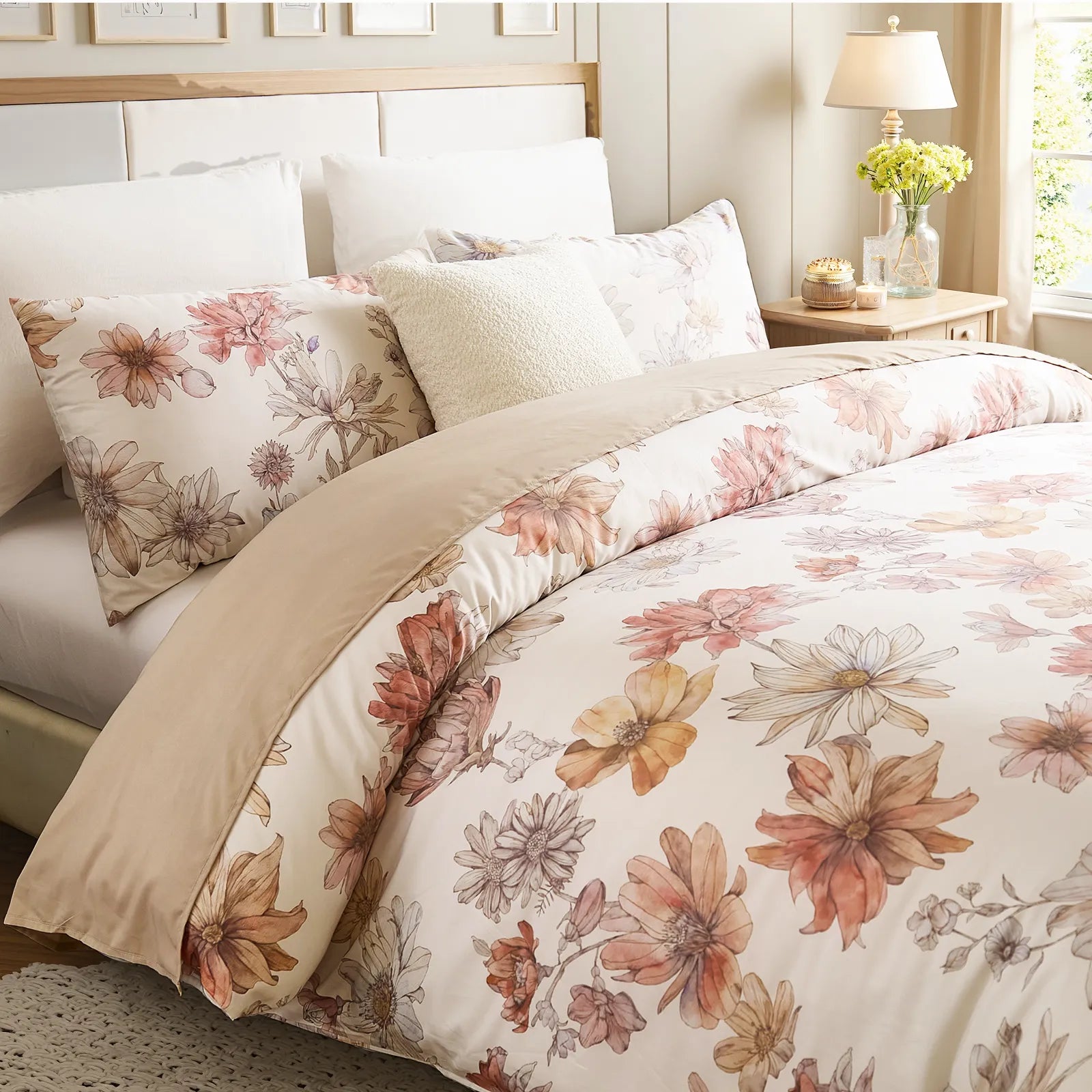 Beautiful floral bedding set with matching pillows and bedside decor including lamp and vase