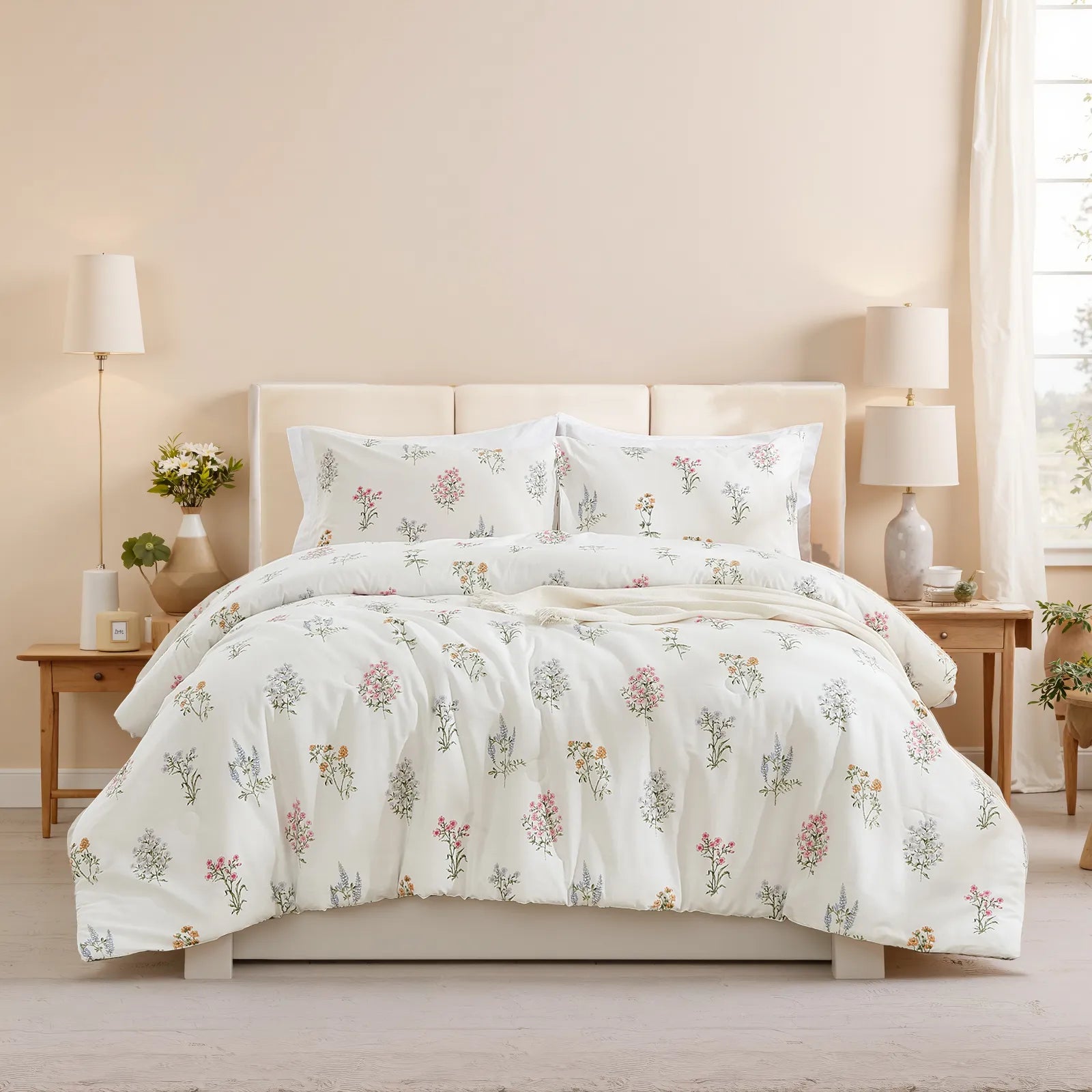 Full room shot showing a bed with a floral comforter set, two matching nightstands, and a large window