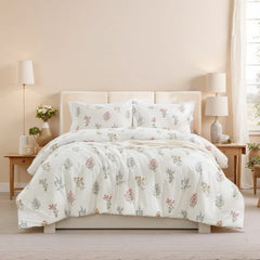 Full room shot showing a bed with a floral comforter set, two matching nightstands, and a large window