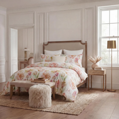 Floral print duvet cover set on a wooden bed in a bright bedroom