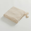 Folded Beige Knitted Throw Blanket Showing Tassel Detail