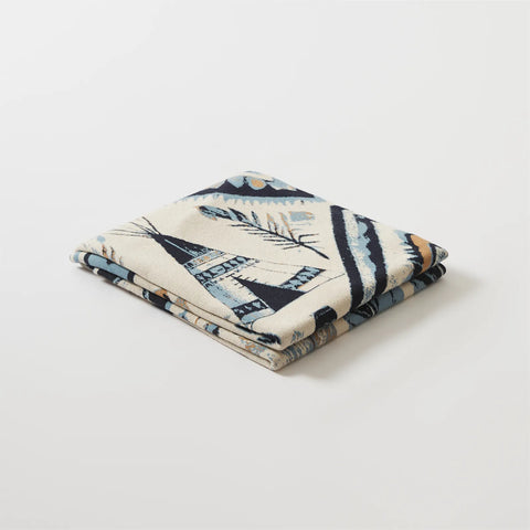  A neatly folded boho-inspired blanket, perfect as a lightweight throw for your couch or bed.
