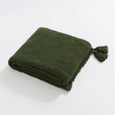 Folded Forest Green Knitted Throw Blanket Showing Tassel on White Background
