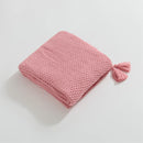 Folded Pink Knitted Throw Blanket Showing Tassel Detail