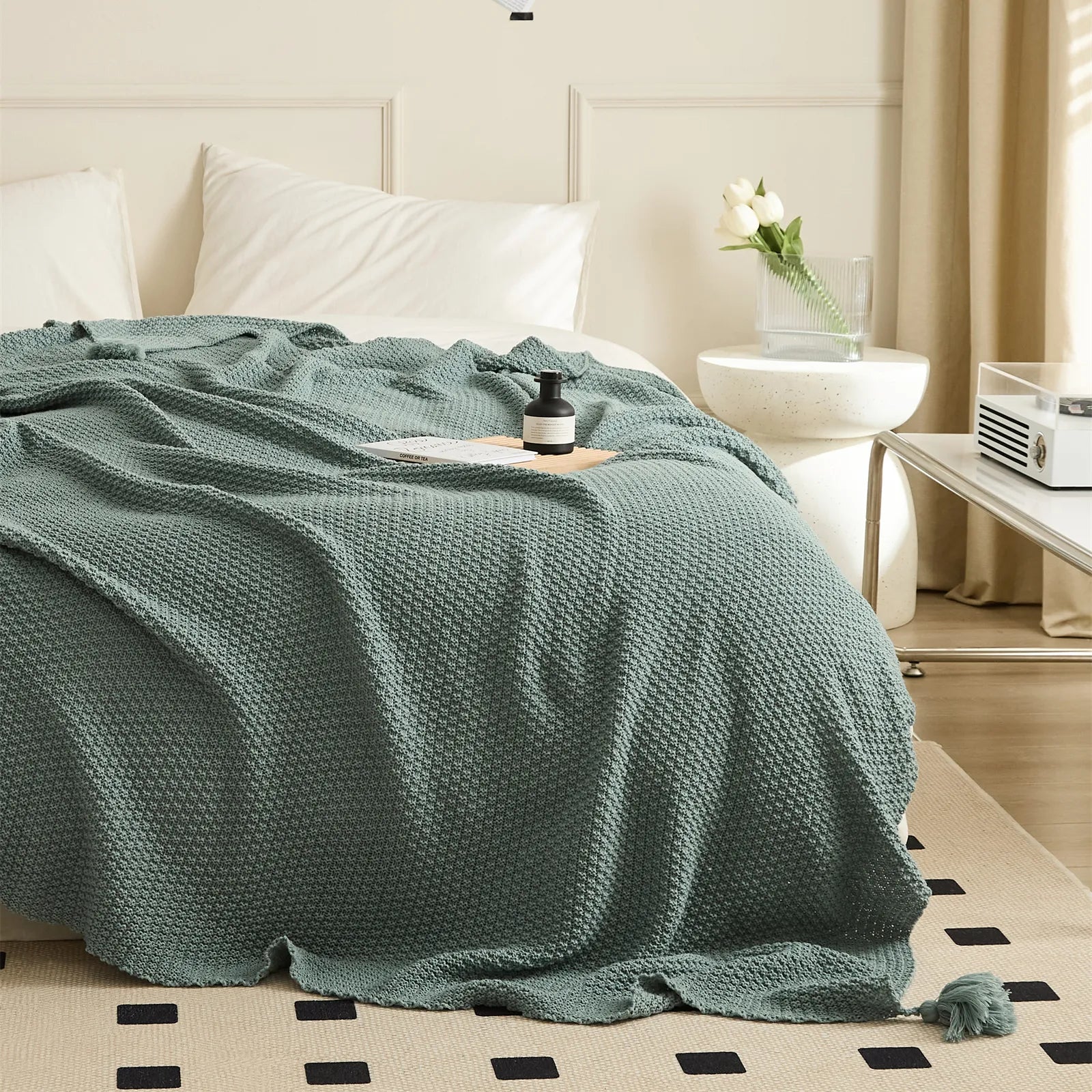 Full View of Aqua Knitted Throw Blanket Showing Tassel by Bedside