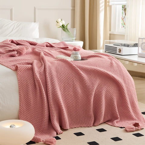 Full View of Pink Knitted Throw Blanket in Cozy Bedroom Decor