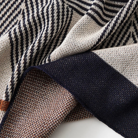  A close-up of the woven geometric pattern on the wool blanket, highlighting its detailed design and trim