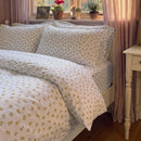 golden ditsy floral duvet cover set nightstand vintage mirror decor