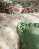 golden ditsy floral duvet cover set with sage green ruffle pillow