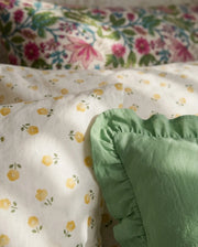 golden ditsy floral duvet cover set with sage green ruffle pillow