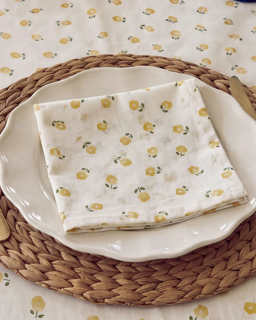 golden ditsy floral napkin folded on plate