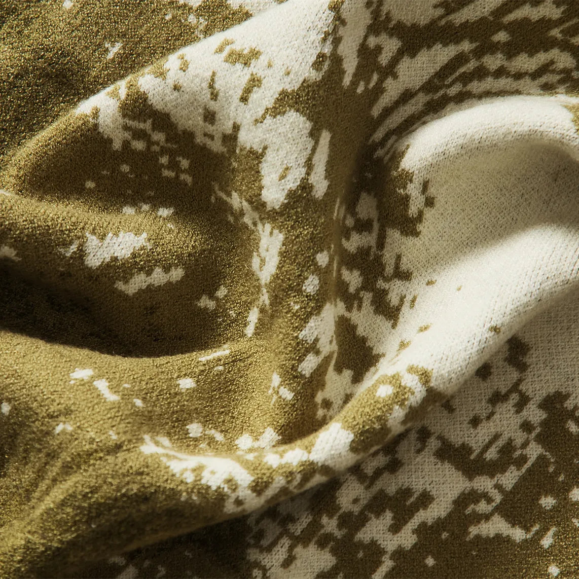A close-up shot of the green forest-inspired blanket's soft, plush fabric, emphasizing its premium feel and high-quality weave.