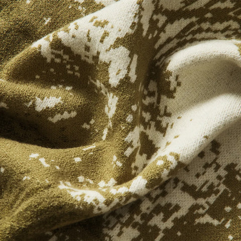 A close-up shot of the green forest-inspired blanket's soft, plush fabric, emphasizing its premium feel and high-quality weave.