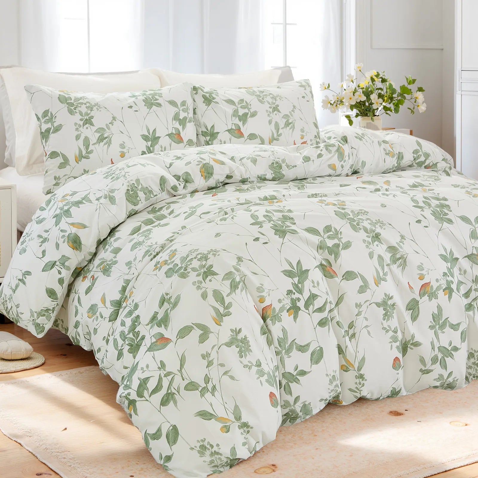 Full view of the green leaf comforter set styled on a bed in a bright room.