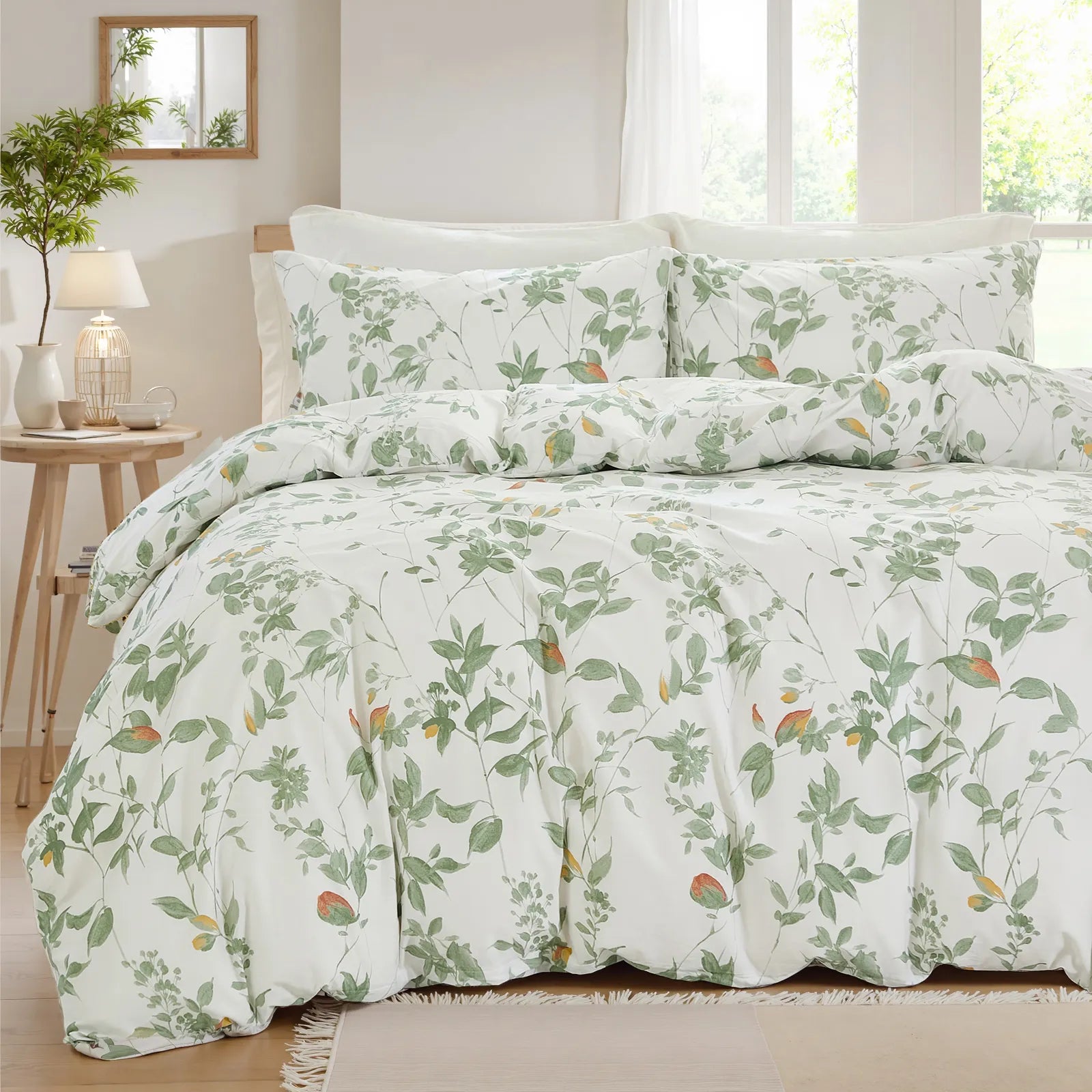 Full view of the green leaf duvet cover set styled on a bed with pillows