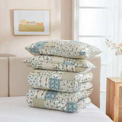 The green patchwork comforter set folded neatly for display.