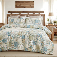 The green patchwork comforter set styled on a bed in a bright, modern bedroom