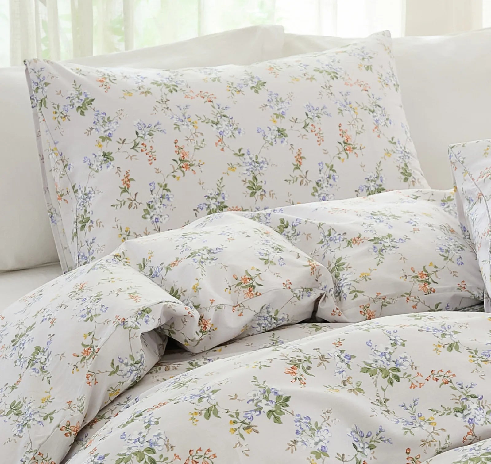 View of the floral pillows and a corner of the duvet cover