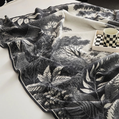 A detailed view of the grey forest landscape blanket, showing the intricate woven pattern and soft texture.