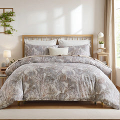 Closeup of the grey leaves comforter and pillowcases on the bed