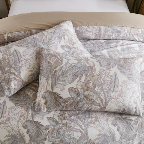 Detailed view of the pillows and comforter with the grey leaves pattern
