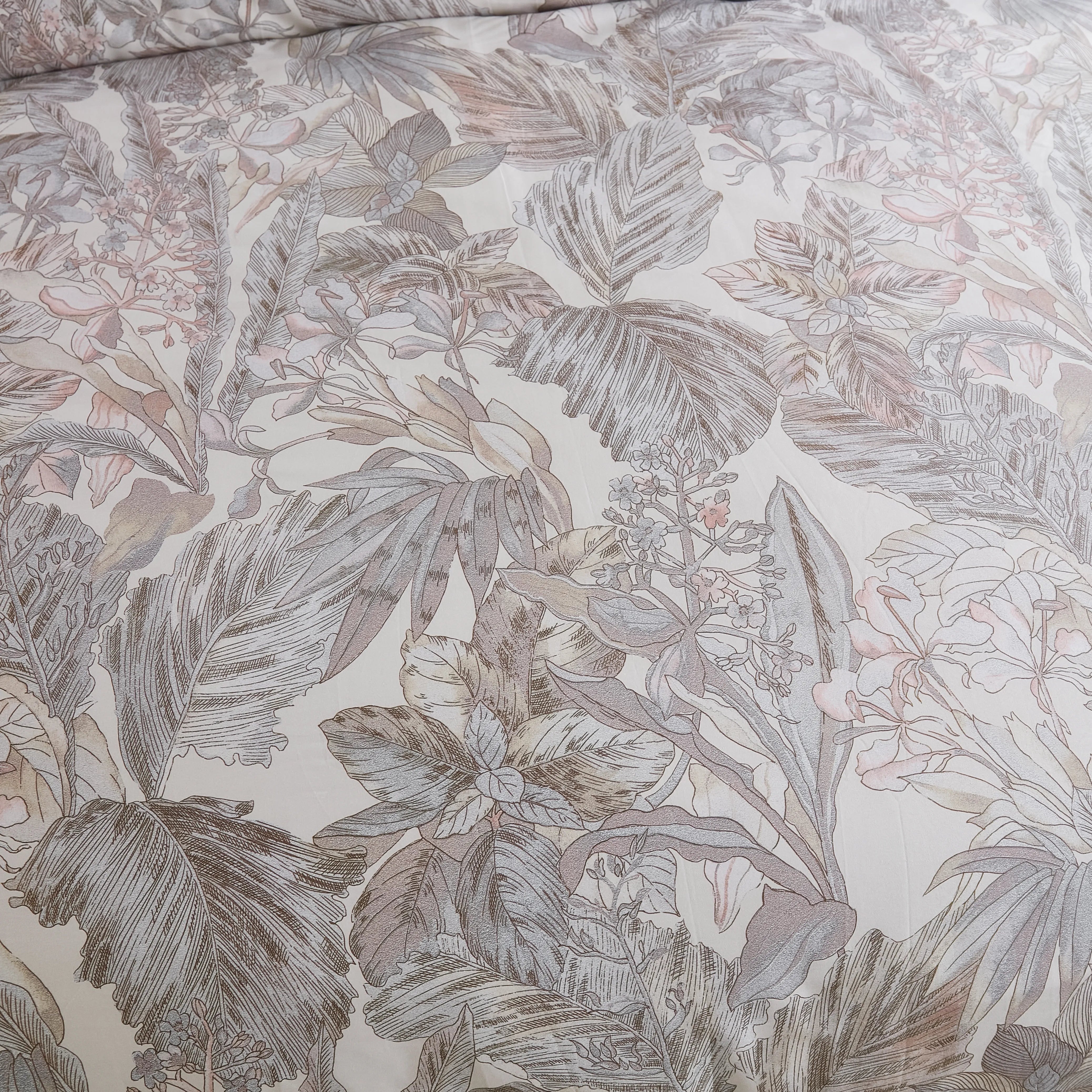 Close-up shot of the comforter's grey leaves pattern and fabric texture