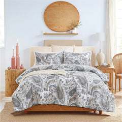 the grey paisley comforter set styled on a bed in a modern bedroom