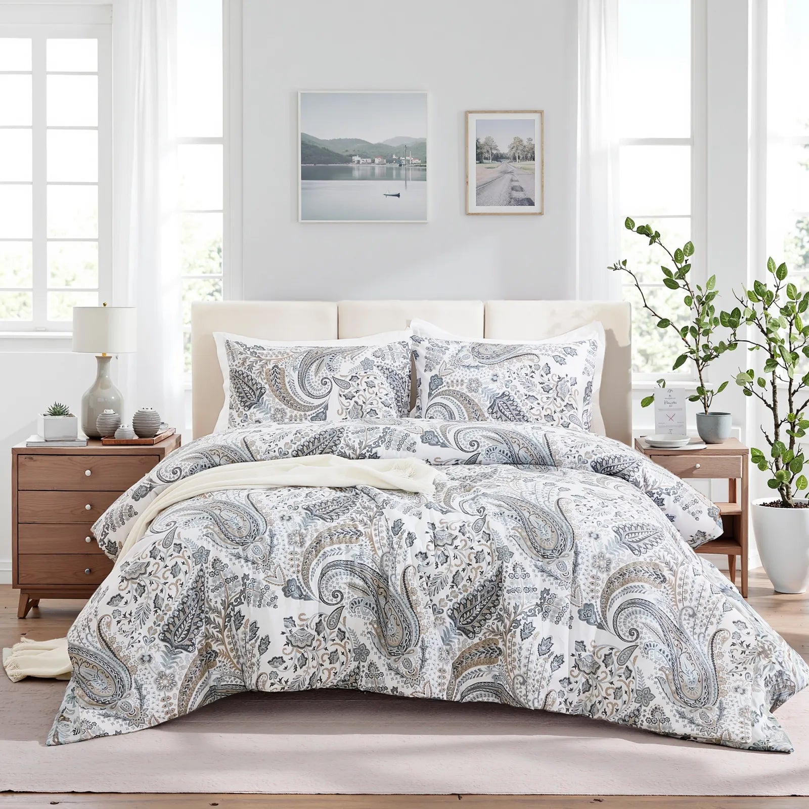 A full view of the grey paisley bedding set with matching pillows