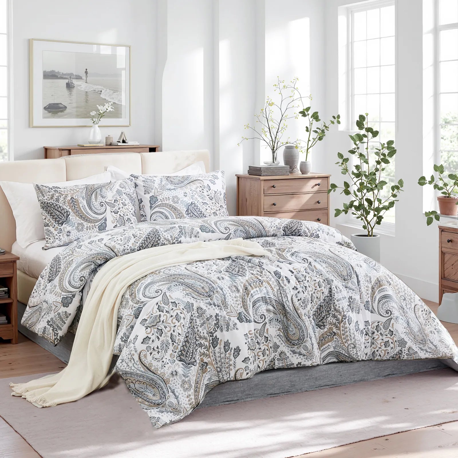 An inviting angled view of the grey paisley duvet cover set with pillows