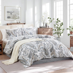 An inviting angled view of the grey paisley duvet cover set with pillows