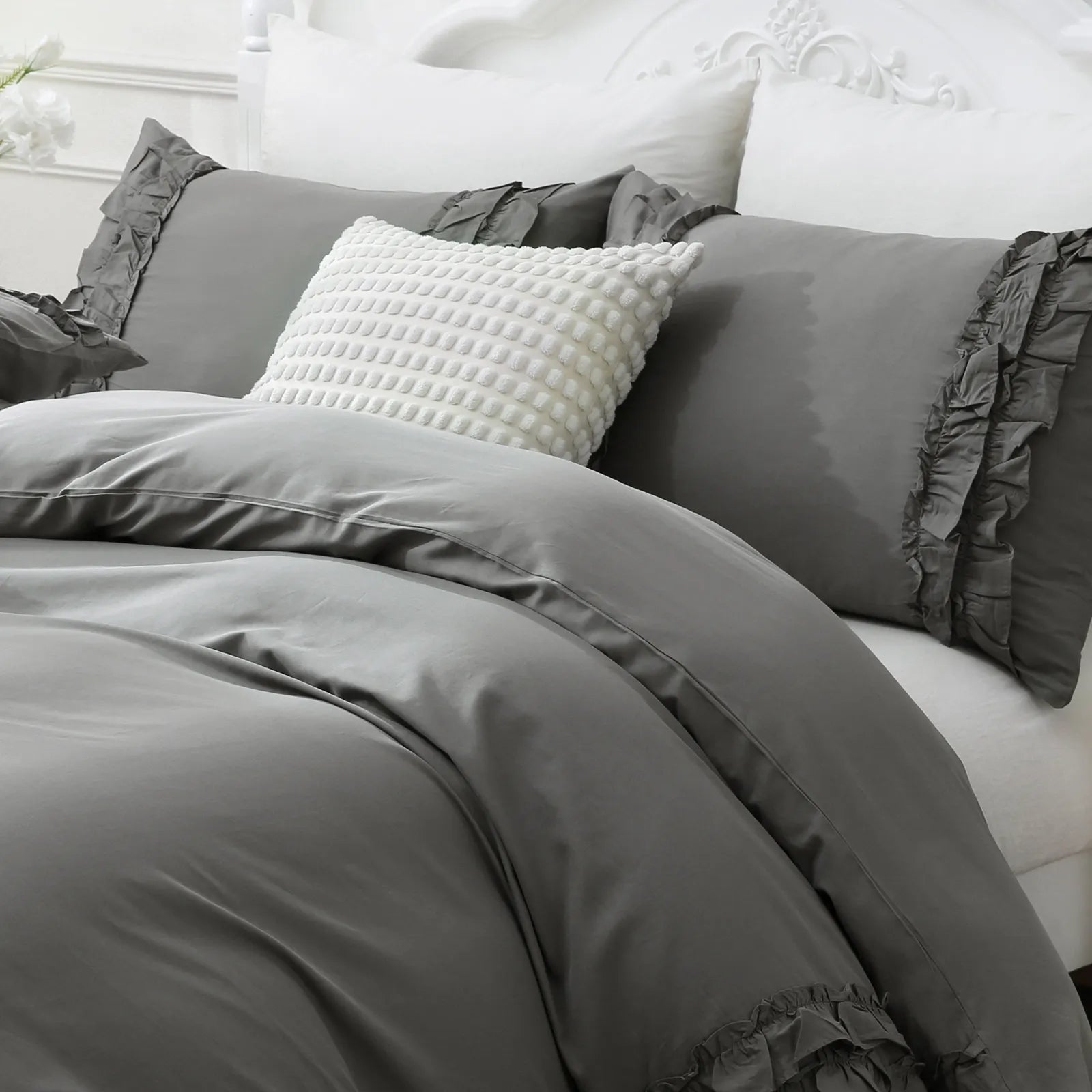 A detailed close-up showing the soft grey fabric and ruffled texture