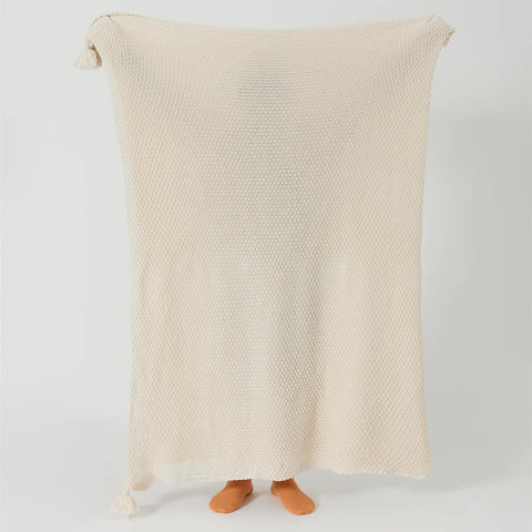 Person Holding Up Beige Knitted Throw Blanket with Tassels Full View