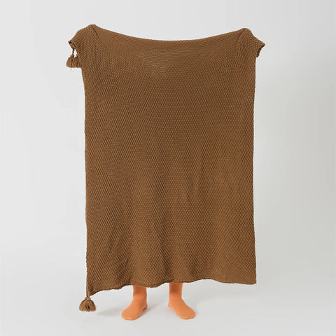 Person Holding Up Brown Knitted Throw Blanket with Tassels Full View